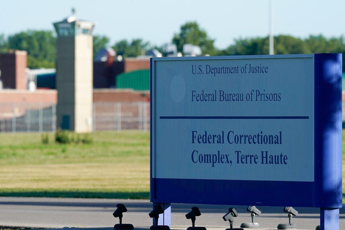 A sign stands outside the Federal Correctional Institution, Terre Haute, as Daniel Lewis Lee, convicted in the killing of three members of an Arkansas family in 1996, is set to be put to death in the first federal execution in 17 years, in Terre Haute, Ind., on July 13, 2020. (Bryan Woolston/Reuters)