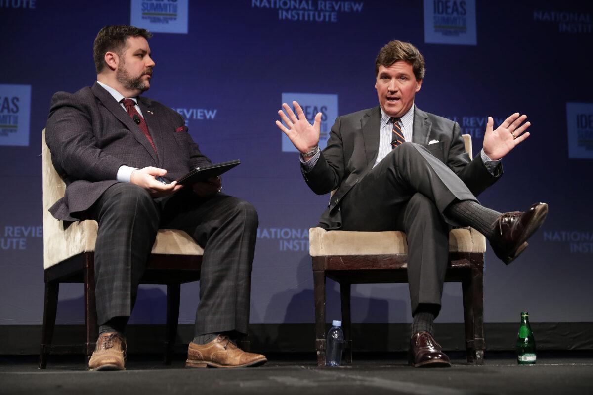 Michael Brendan Dougherty (L) and Fox News host Tucker Carlson talk during the National Review Institute's Ideas Summit at the Mandarin Oriental Hotel in Washington on March 29, 2019. (Chip Somodevilla/Getty Images)