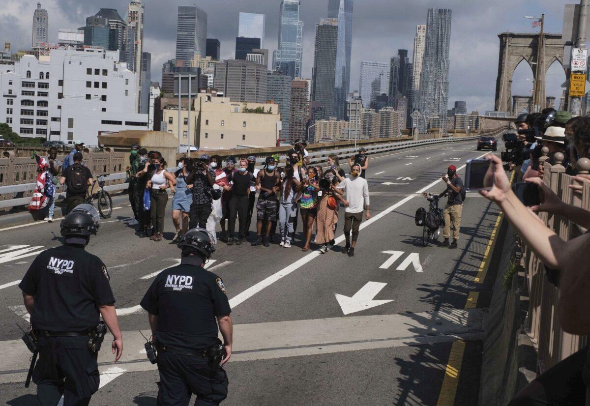NYPD stand on the Brooklyn Bridge as Black Lives Matter protests on July 15, 2020, in New York. (Yuki Iwamura/AP Photo)