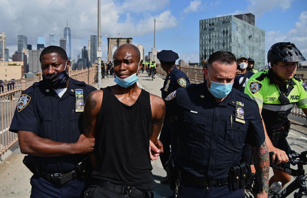 People get arrested on the Brooklyn Bridge after about a dozen Black Lives Matter protesters briefly shut down the bridge in New York City, on July 15, 2020. (Angela Weiss/AFP via Getty Images)