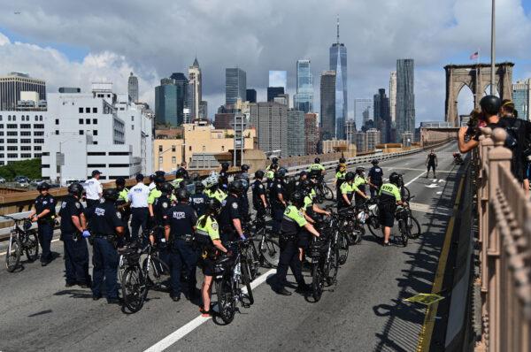 People are arrested on the Brooklyn Bridge after about a dozen Black Lives Matter protesters briefly shut down the bridge in New York City, on July 15, 2020. (Angela Weiss/AFP via Getty Images)