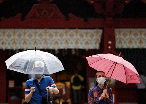 Visitors wearing protective face masks are seen at a shrine amid the coronavirus outbreak, in Tokyo, on July 15, 2020. (Issei Kato/Reuters)