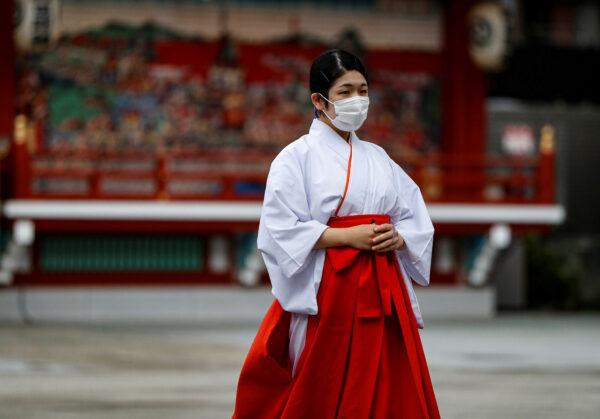 A Shinto maiden wearing a protective face mask walks at a shrine amid the coronavirus outbreak, in Tokyo, Japan, on July 15, 2020. (Issei Kato/Reuters)