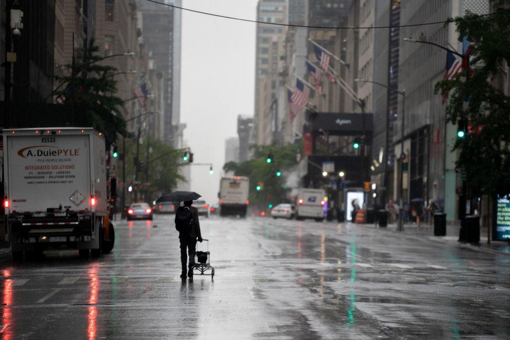 A pedestrian walks down 5th Avenue as Tropical Storm Fay passes over New York City on July 10, 2020 (David Dee Delgado/Getty Images)