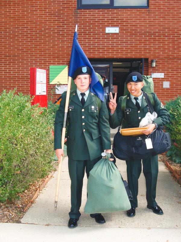 A young Samuel Johnson carries the flag and a duffel bag outside an Army facility. (Courtesy of Samuel Johnson)