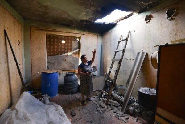 A local woman shows damage in her house after the shelling by the Azerbaijan side in the Aygepar village in Armenia's Tavush region, Armenia, on July 15, 2020. (Karo Sahakyan/AP Photo)