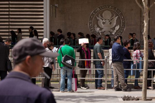 Chinese citizens wait in line to submit their visa applications at the US Embassy in Beijing, China on April 27, 2012. (Ed Jones/AFP/GettyImages)