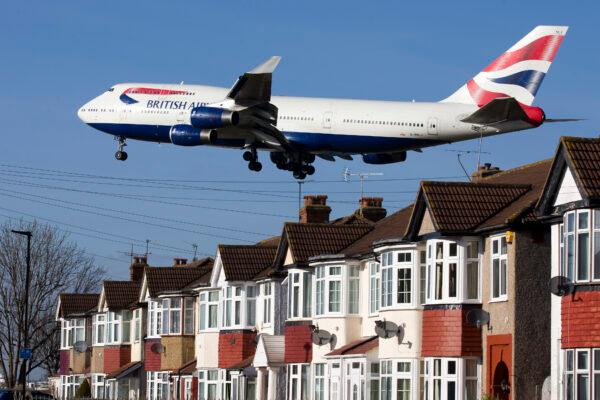 A British Airways 747 aircraft flies over roof tops as it comes into land at Heathrow Airport in west London on Feb. 18, 2015. (Justin Tallis/AFP via Getty Images)