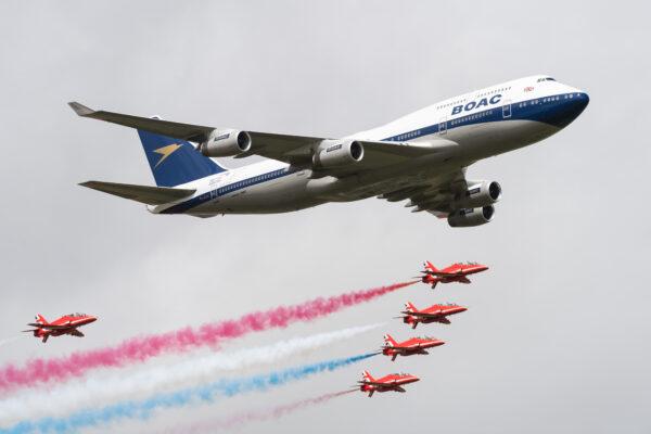 A British Airways special liveried Boeing 747 takes to the skies alongside the Red Arrows during the 2019 Royal International Air Tattoo on July 20, 2019, at RAF Fairford, England. (Ian Gavan/Getty Images for British Airways)