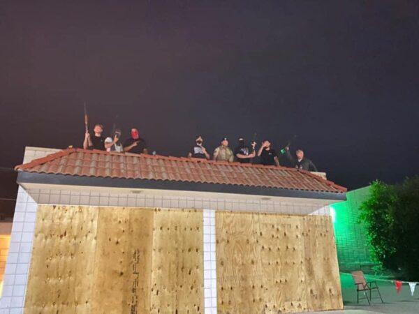 An image circulating on social media shows armed men on the roof of a business in Yucaipa, Calif.