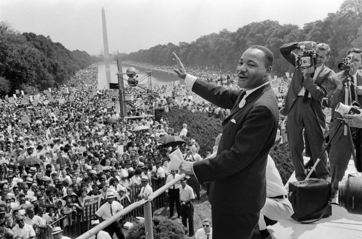 The civil rights leader Martin Luther King Jr. (C) waves to supporters on the Mall in Washington on Aug. 28, 1963. (-/AFP via Getty Images)