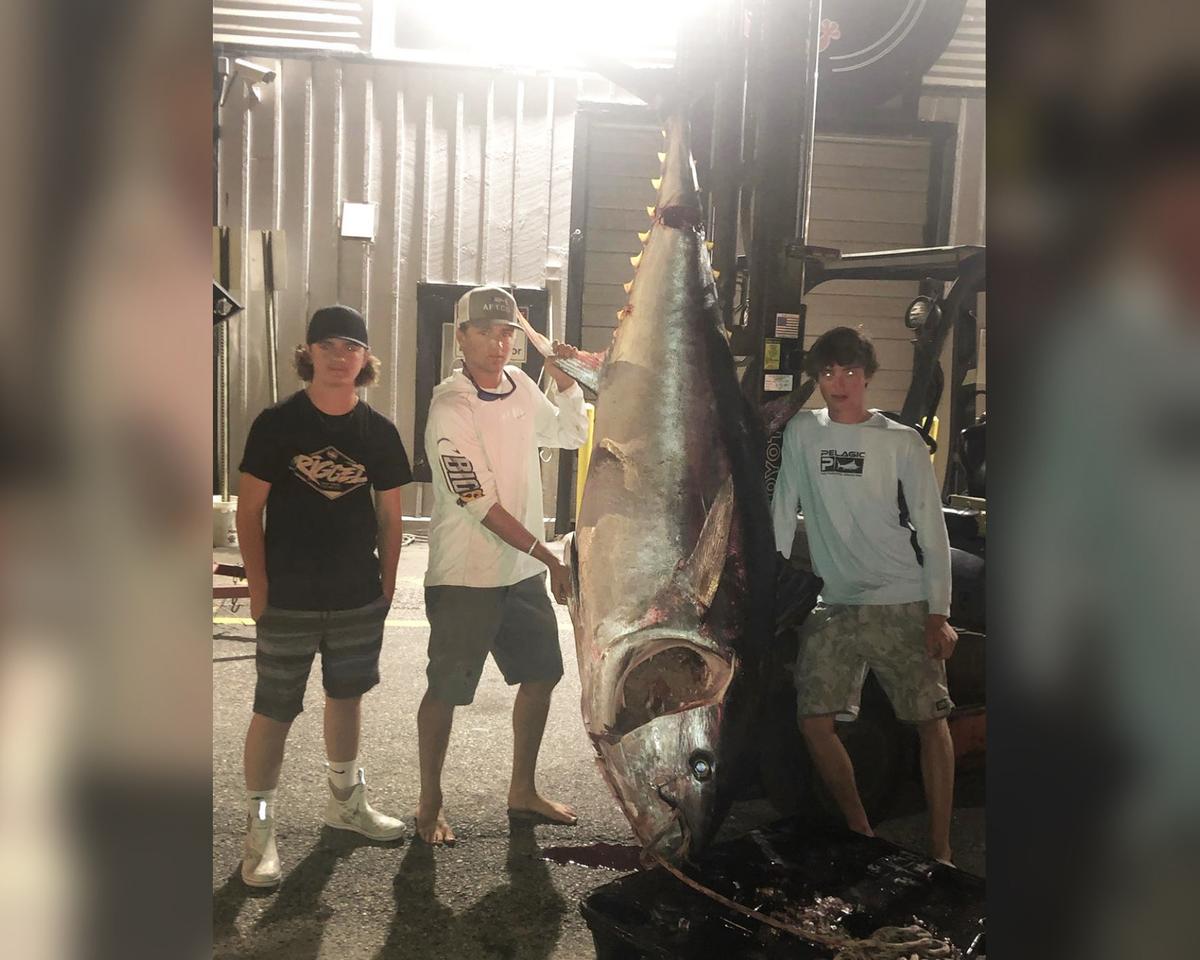 Griffin Buckwalter, Wyatt Morse, and Martin Scanlan reeled in the giant tuna after seven hours. (Courtesy of Griffin Buckwalter)