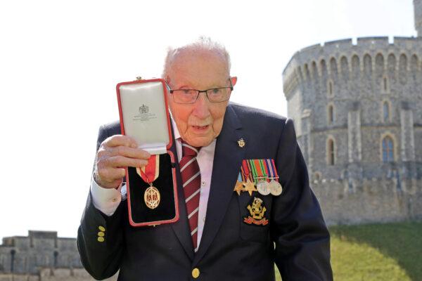 Captain Tom Moore poses after being awarded with the insignia of Knight Bachelor by Britain's Queen Elizabeth at Windsor Castle, in Windsor, Britain July 17, 2020. (Chris Jackson/Pool via Reuters)