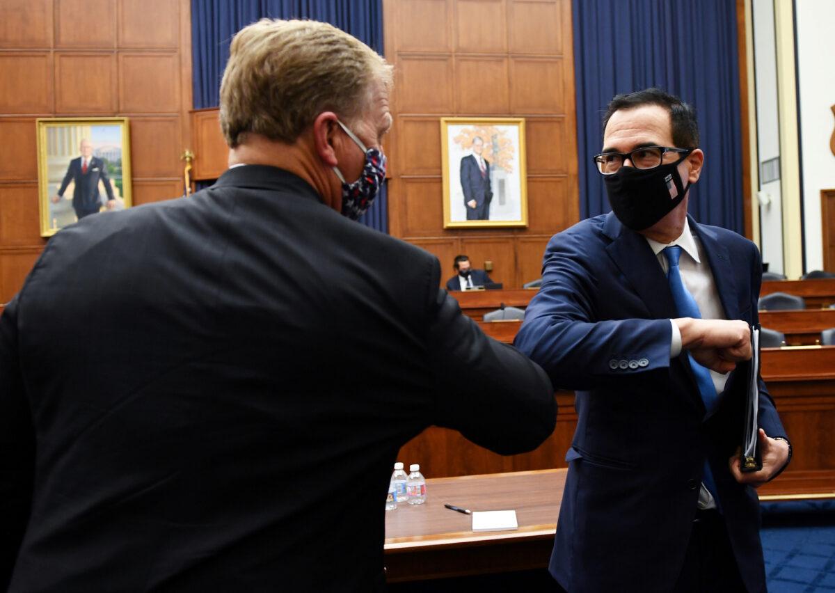 Treasury Secretary Steven Mnuchin bumps elbows with Rep. Kevin Hern (R-Okla.) after testifying at the Capitol in Washington, on July 17, 2020. (Kevin Dietsch/Pool via Reuters)