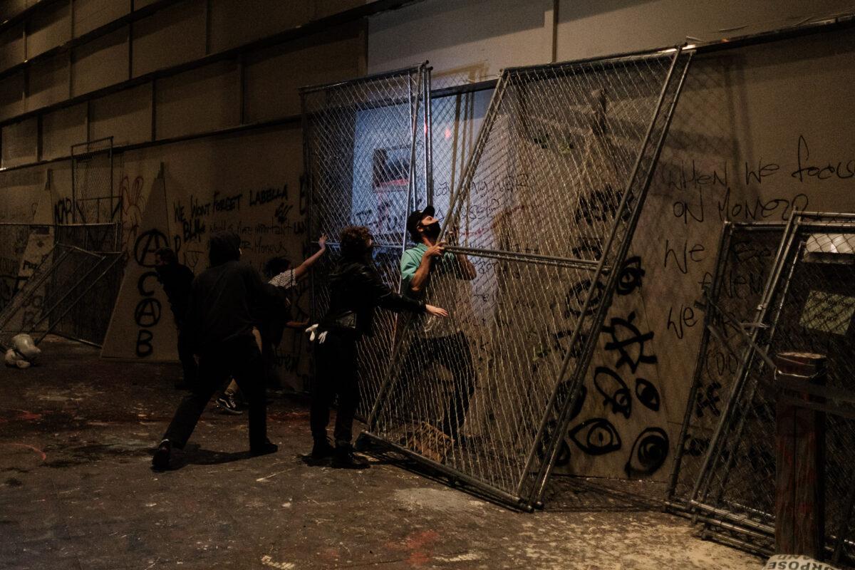 Rioters use fencing to barricade an exit from the Mark O. Hatfield Courthouse in Portland, Ore on July 17, 2020. (Mason Trinca/Getty Images)