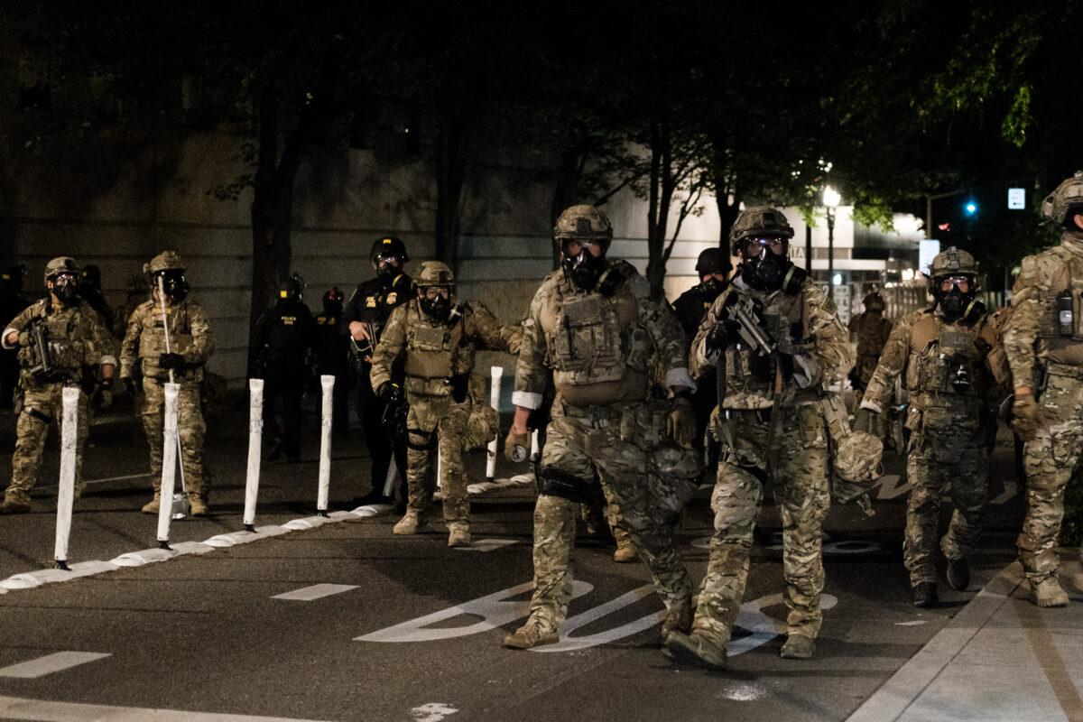 Federal officers prepare to disperse a crowd outside the Multnomah County Justice Center in Portland, Ore., on July 17, 2020. (Mason Trinca/Getty Images)