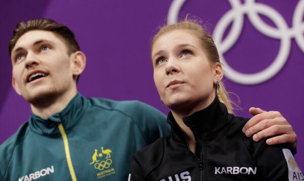 Ekaterina Alexandrovskaya and Harley Windsor of Australia watch as their scores are posted after their performance in the pair figure skating short program in the Gangneung Ice Arena at the 2018 Winter Olympics in Gangneung, South Korea, on Feb. 14, 2018. (Bernat Armangue/AP)
