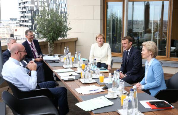 President of the European Council Charles Michel (L), Germany's Chancellor Angela Merkel (C), France's President Emmanuel Macron (2nd R) and President of the European Commission Ursula von der Leyen talk during a meeting at the first face-to-face EU summit since the COVID-19 outbreak, in Brussels, Belgium, on July 19, 2020. (Francois Walschaerts/Pool via Reuters)