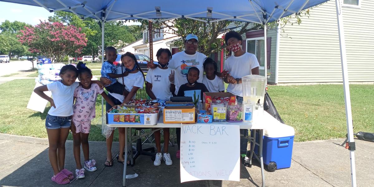 Cartier Carey (center) is working hard to provide relief for single mothers one cup of lemonade at a time. (Courtesy of Britany Stewart)