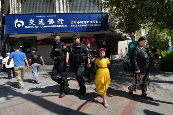 Chinese armed police patrol the streets of the Muslim Uighur quarter in Urumqi, China on June 29, 2013. (MARK RALSTON/AFP via Getty Images)