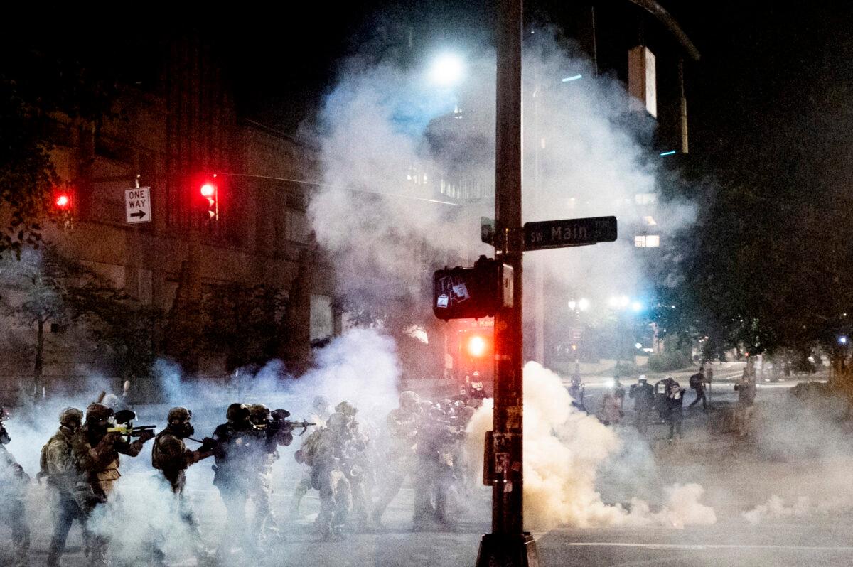 Federal agents use crowd control munitions to disperse rioters near the Mark O. Hatfield United States Courthouse in Portland, Ore., July 20, 2020. (Noah Berger/AP Photo)