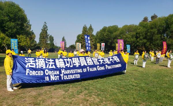 Falun Dafa practitioners hold signs at Townsend Park in San Jose, Calif., on July 18, 2020, to raise awareness of the Chinese Communist Party’s crime of forced organ harvesting against Falun Dafa practitioners. (David Lam/The Epoch Times)