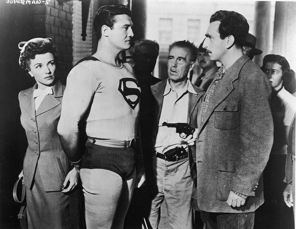 Actor George Reeves (1914–1959), as Superman, stands in front of actress Phyllis Coates, as Lois Lane, in a still from the television series "Adventures of Superman," circa 1952. (Hulton Archive/Courtesy of Getty Images)