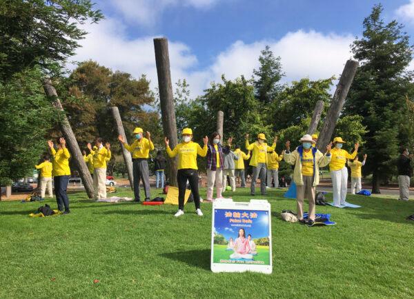 Falun Dafa practitioners do a meditative standing exercise at Marina Park in San Leandro, Calif., on July 18, 2020. (Ilene Eng/The Epoch Times)