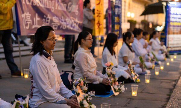 Falun Gong practitioners mark the 21st anniversary of the persecution against Falun Gong with a candle vigil relay while maintaining social distance during the CCP virus outbreak, opposite the Chinese Embassy in central London on July 20, 2020. (Yanning/The Epoch Times)