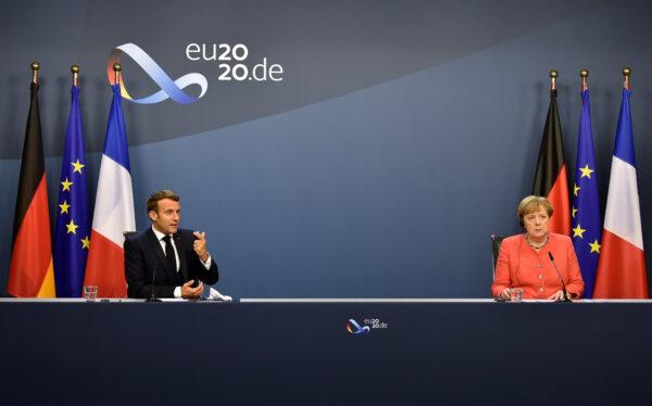 German Chancellor Angela Merkel (R) and French President Emmanuel Macron (L) give a joint press at the end of the European summit at the EU headquarters in Brussels on July 21, 2020. (John Thys/Pool via Reuters)