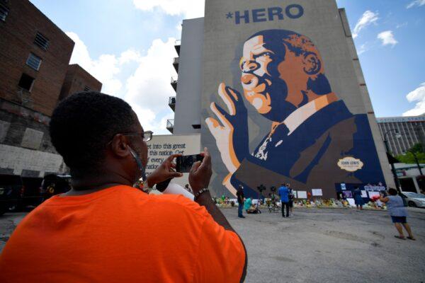 People gather at a make-shift memorial near the home of Rep. John Lewis (D-Ga.), in Atlanta, on July 19, 2020. (Mike Stewart/AP Photo)