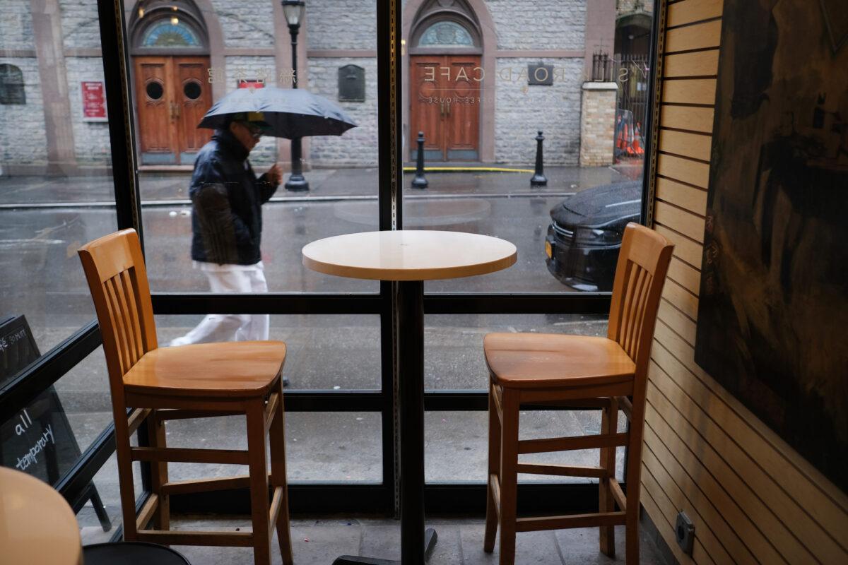 People walk by an empty coffee shop in New York City, on Feb. 13, 2020. (Spencer Platt/Getty Images)