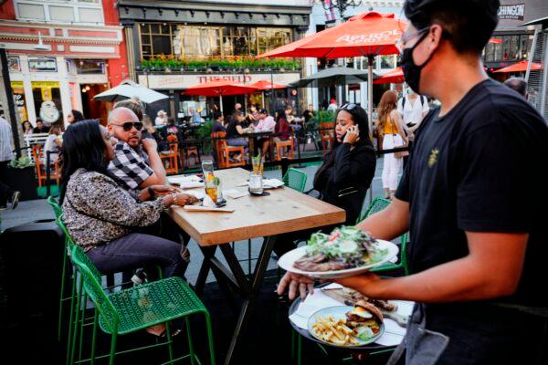 Patrons dine at an outdoor restaurant along 5th Avenue in downtown San Diego, Calif., on, July 17, 2020. (Sandy Huffaker/AFP via Getty Images