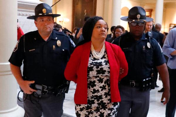 Sen. Nikema Williams (D-Atlanta) is detained by capitol police during a protest over election ballot counts in the rotunda of the state capitol building, in Atlanta, on Nov. 13, 2018. (John Bazemore/File/AP Photo)