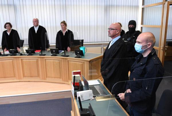 Stephan Balliet, accused of shooting two people after an attempt to storm a synagogue in Halle, and his lawyer Hans-Dieter Weber wait for the start of the trial at a local court in Magdeburg, Germany, July 21, 2020. In the background left is presiding Judge Ursula Mertens. (Hendrik Schmidt/Pool via Reuters)