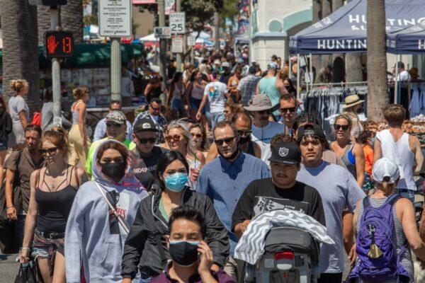 People cross the street in Huntington Beach amid the CCP virus pandemic, in California on July 19, 2020. (Apu Gomes/ AFP via Getty Images)