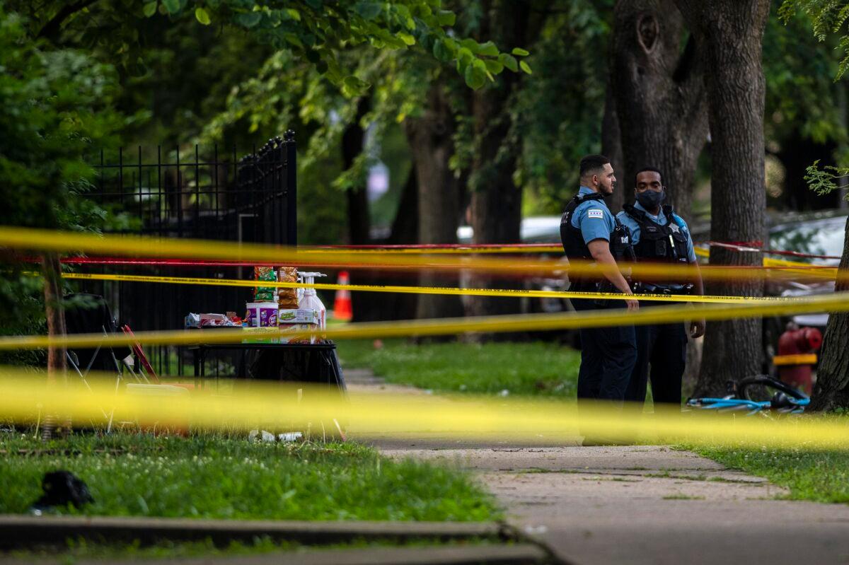 Chicago police investigate the scene where multiple people were shot in the 8200 block of South Drexel, in the Chatham neighborhood of Chicago, on July 17, 2020. (Tyler LaRiviere/Chicago Sun-Times via AP)