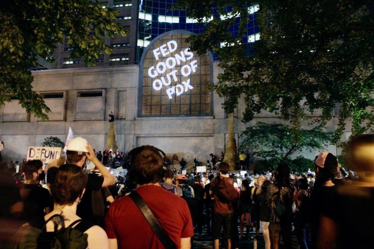 Demonstrators projected words onto the front of the Multnomah County Justice Center in Portland, Ore., on July 20, 2020. (Gillian Flaccus/AP Photo)