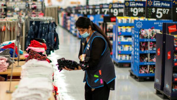 A worker wears a mask while organizing merchandise at a Walmart store, in North Brunswick, N.J., on July 20, 2020. (Eduardo Munoz/Reuters)