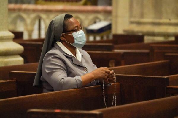 A nun prays as St. Patrick's Cathedral re-opens for Mass at 25% capacity during the COVID-19 pandemic in New York, on June 28, 2020. (Bryan R. Smith / AFP via Getty Images)