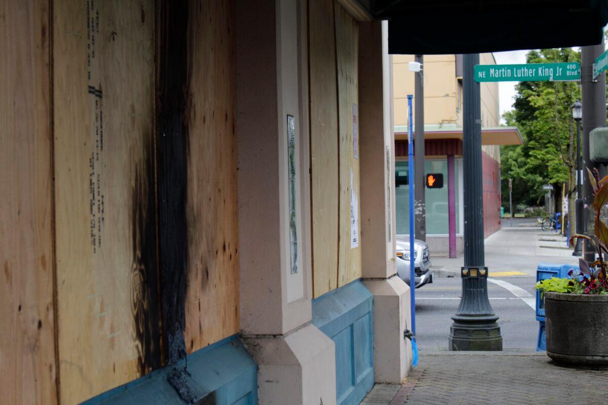  Damage from a recent fire set by demonstrators seen on the boarded-up windows of a hair products business that caters to African-American customers in a historically Black neighborhood in Portland, Ore., on July 1, 2020. (Gillian Flaccus/AP Photo)