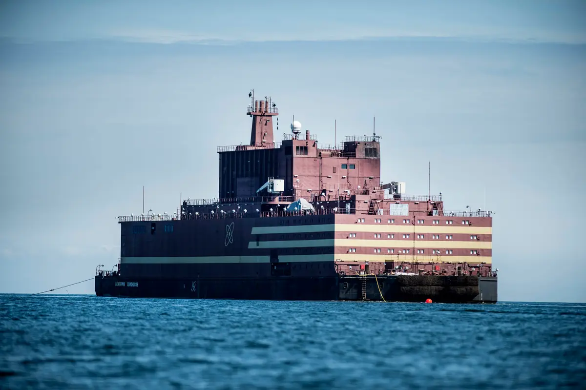 The world's first floating nuclear power plant, Russian "Akademik Lomonosov," passes by the island of Langeland, off the coast of Spodsbjerg in Denmark, on May 4, 2018, as it is pulled through the Baltic Sea to Murmansk. (Tim Kildeborg Jensen/AFP via Getty Images)