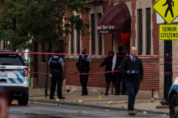 Chicago police investigate the scene of a mass shooting where more then a dozen people were shot in the Gresham neighborhood, on July 21, 2020. (Tyler LaRiviere/Sun-Times/AP)
