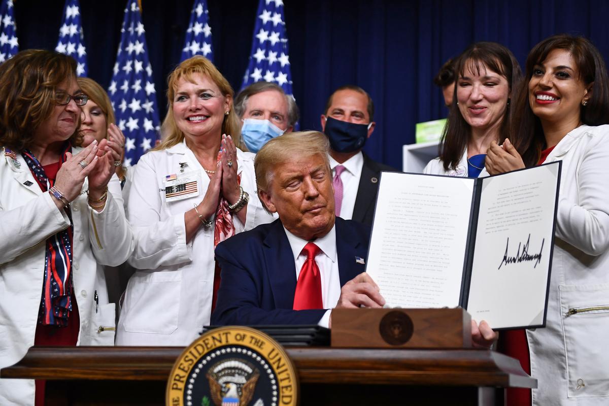 President Donald Trump signs an executive order on lowering drug prices at the White House in Washington on July 24, 2020. (Brendan Smialowski/AFP via Getty Images)