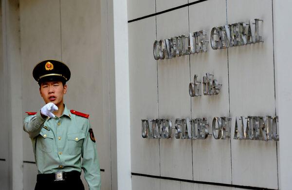 A Chinese paramilitary policeman gestures to photographers at the entrance to the U.S. consulate in Chengdu, China, on Sept. 17, 2012. (Goh Chai Hin/AFP/GettyImages)