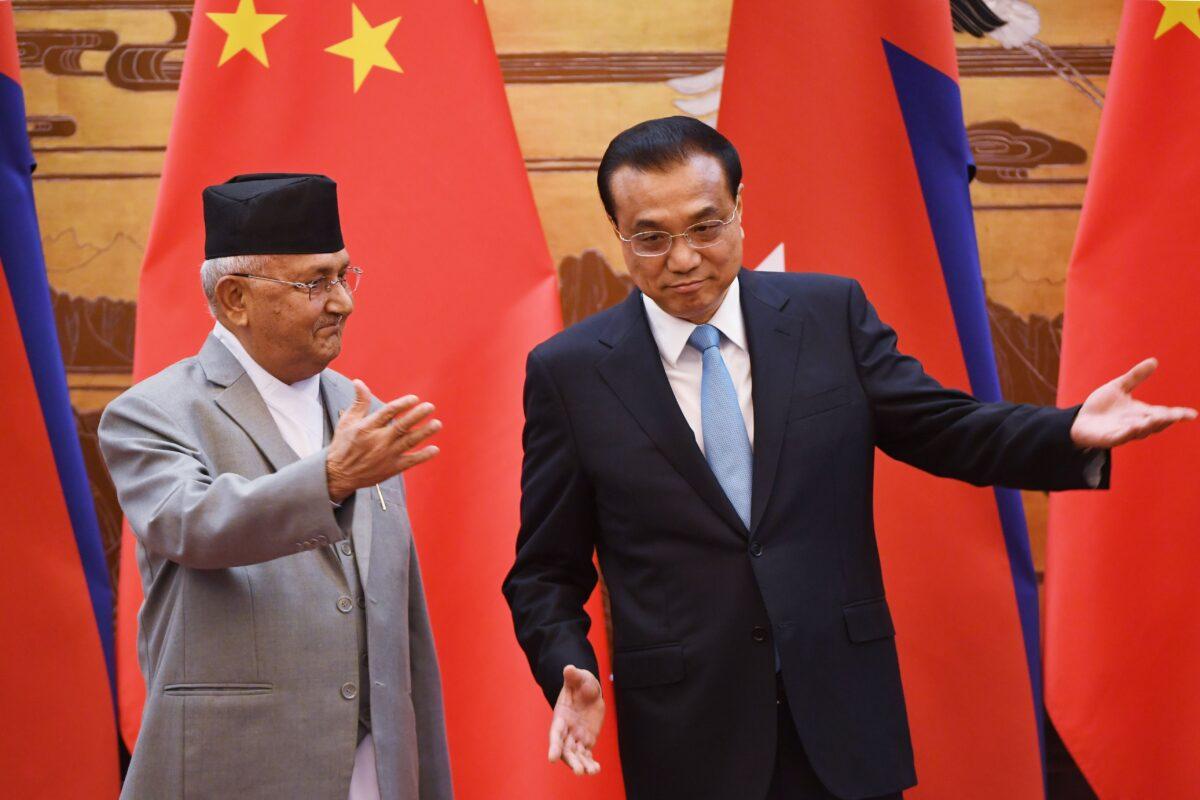 Nepali Prime Minister K.P. Sharma Oli (L) after shaking hands with Chinese Premier Li Keqiang following a signing ceremony at the Great Hall of the People in Beijing on June 21, 2018. (GREG BAKER/AFP via Getty Images)