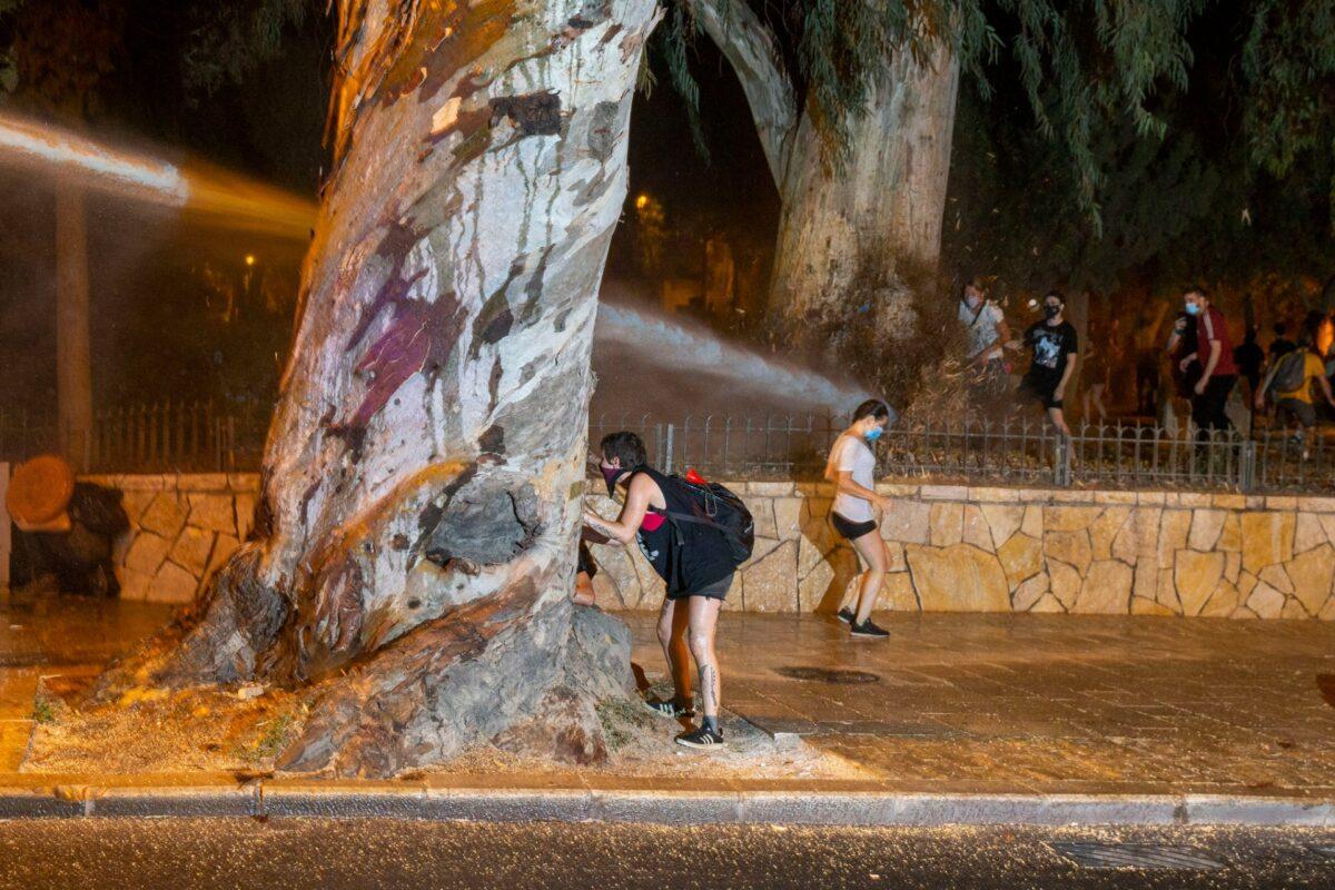 Israeli Police use a water cannon to disperse demonstrators during a protest against Israel's Prime Minister Benjamin Netanyahu outside his residence in Jerusalem, on July 24, 2020. (Ariel Schalit/AP Photo)