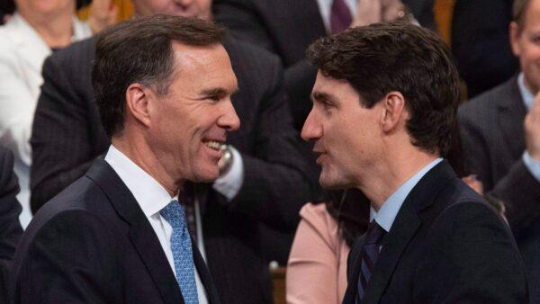 Prime Minister Justin Trudeau congratulates Minister of Finance Bill Morneau following the fall fiscal update in the House of Commons in Ottawa, on Nov. 21, 2018. (The Canadian Press/Adrian Wyld)