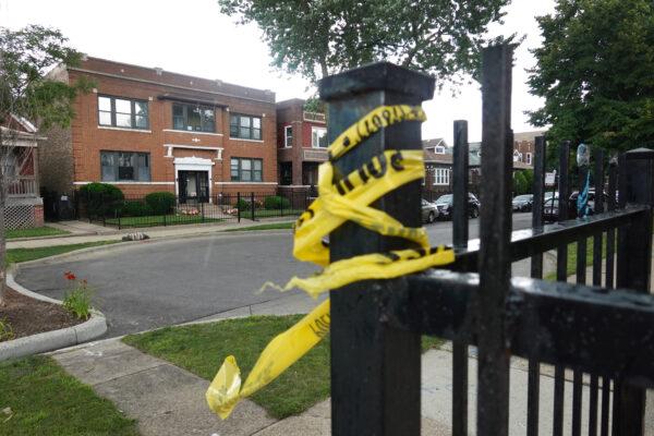 Crime scene tape remains on a fence near the Rhodes funeral home, where 15 people were shot July 21 during a funeral for a shooting victim, in Chicago’s Auburn Gresham neighborhood on July 22, 2020. (Scott Olson/Getty Images)