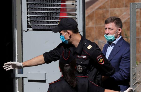 Governor of Khabarovsk Region Sergei Furgal, accused of crimes including attempted murder, is escorted to a police vehicle after a court hearing in Moscow, Russia, on July 10, 2020. (Evgenia Novozhenina/Reuters)
